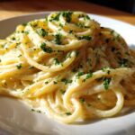 Close-up of a serving of Creamy Lemon Pasta coated in a rich sauce and sprinkled with fresh parsley.