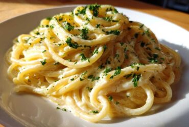 Close-up of a serving of Creamy Lemon Pasta coated in a rich sauce and sprinkled with fresh parsley.