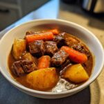 Close-up of tender beef chunks, carrots, and potatoes in rich gravy from the crockpot beef stew recipe.