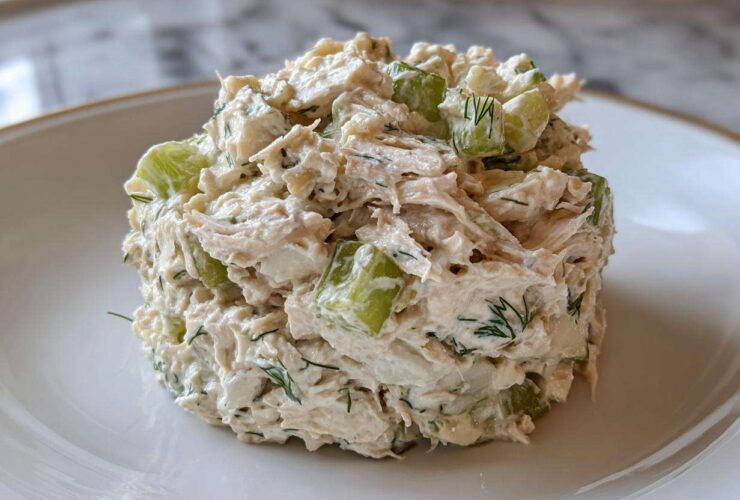 A perfectly molded scoop of creamy cottage cheese chicken salad mixed with crisp celery chunks and fresh dill.