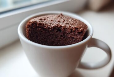 A rich, dark chocolate Cottage Cheese Microwave Brownie baked and served directly in a white mug.