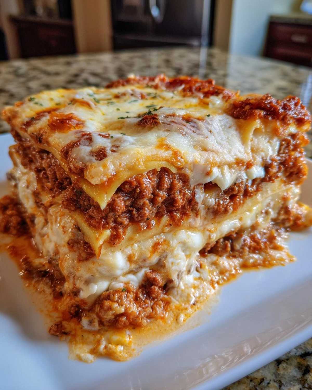 Close-up of a thick, cheesy slice of homemade lasagna layered with rich meat sauce.