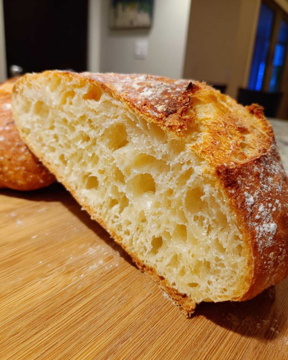 Close-up of the airy, open crumb structure inside a freshly baked loaf of italian bread.