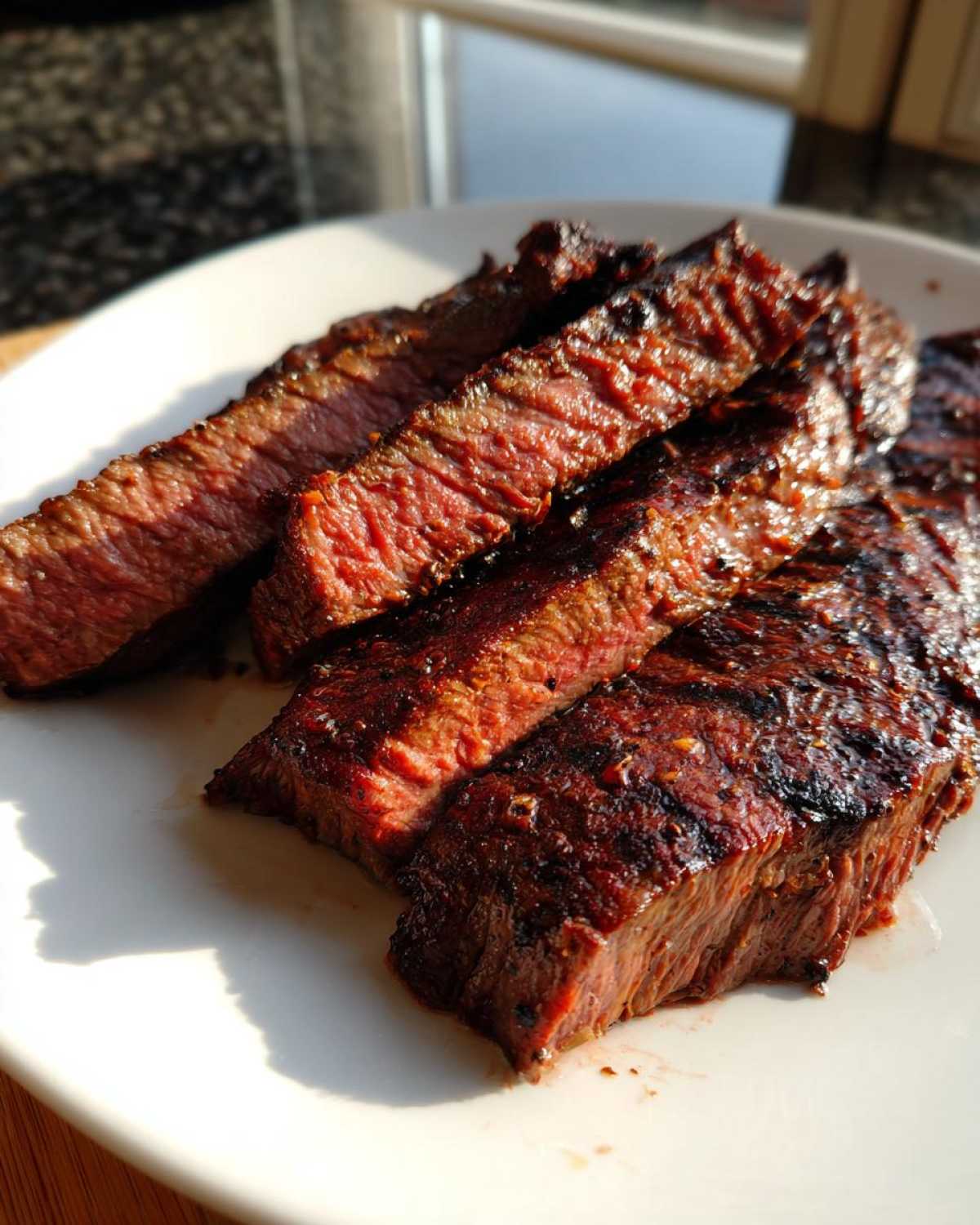 Close-up of medium-rare sliced steak, showing the rich color achieved with a good carne asada marinade.