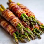 Close-up of perfectly cooked Keto Bacon Wrapped Asparagus Bundles, seasoned and ready to eat.