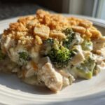 A close-up serving of Cheesy Chicken and Broccoli Bake Comfort Dish with a golden, crumbly topping.