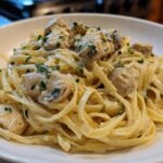 Close-up of fettuccine pasta coated in rich sauce with chunks of chicken, part of the Creamy Alfredo Chicken Pasta Easy Recipe.