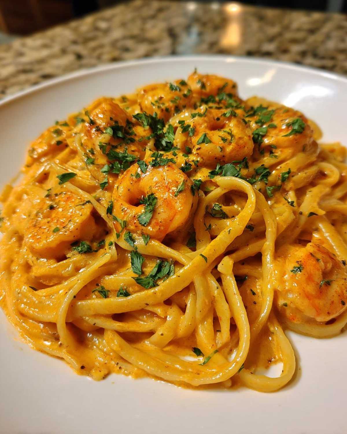 A close-up of rich, creamy Cajun shrimp pasta topped with fresh parsley, showcasing the bold flavor.
