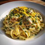 Close-up of Creamy Lemon Garlic Pasta with Chicken, topped with parsley and lemon zest.