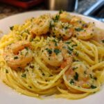 Close-up of Creamy Lemon Shrimp Pasta topped with sautéed shrimp and fresh parsley.