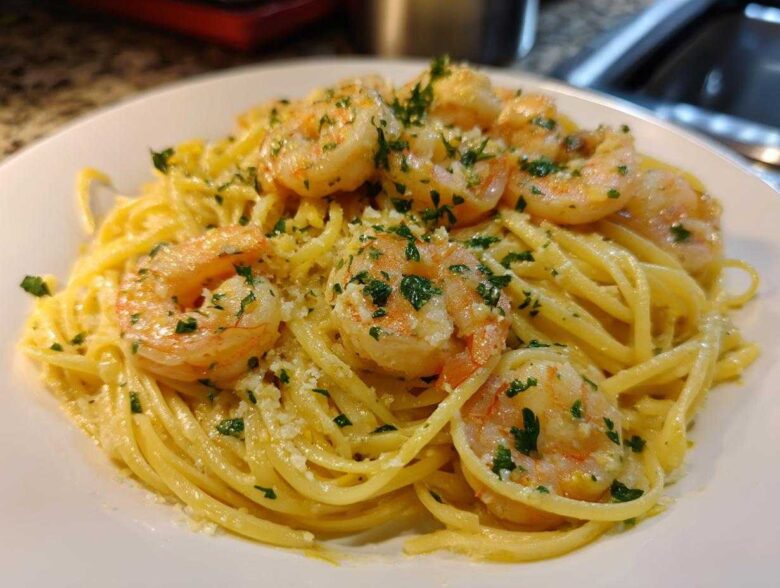 Close-up of Creamy Lemon Shrimp Pasta topped with sautéed shrimp and fresh parsley.