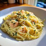 A close-up of delicious Creamy Lemon Shrimp Pasta with Garlic Sauce, topped with fresh parsley.
