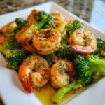 Close-up of succulent shrimp and bright green broccoli coated in rich garlic butter sauce from the Garlic Butter Shrimp and Broccoli Skillet.