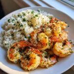 A plate of Garlic Butter Shrimp with Rice Skillet, featuring plump shrimp coated in garlic butter and fresh parsley next to fluffy white rice.