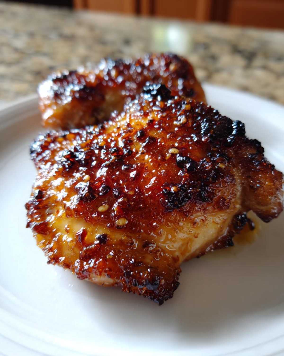 Close-up of Honey Garlic Chicken Thighs with crispy, caramelized, and glossy skin.