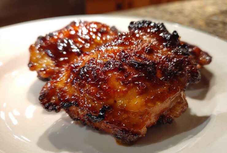 Close-up of a perfectly cooked Honey Soy Chicken Thighs with crispy, caramelized edges and a shiny glaze.