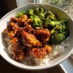 Close-up of a bowl containing Sticky Teriyaki Chicken Easy Weeknight Meal served over white rice with steamed broccoli.