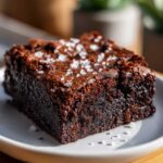 Close-up of a fudgy Brown Butter Brownies square topped with flaky sea salt crystals.