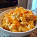 Close-up of creamy, cheesy Chick-fil-A Mac and Cheese topped with melted, slightly browned cheese in a white bowl.
