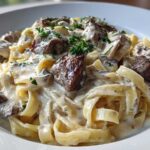 Close-up of Creamy Steak Pasta featuring tender steak pieces tossed in a rich, garlic cream sauce with fettuccine pasta.