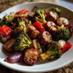 Close-up of Honey Garlic Kielbasa & Veggies featuring glazed sausage slices, roasted broccoli, red peppers, and onions.