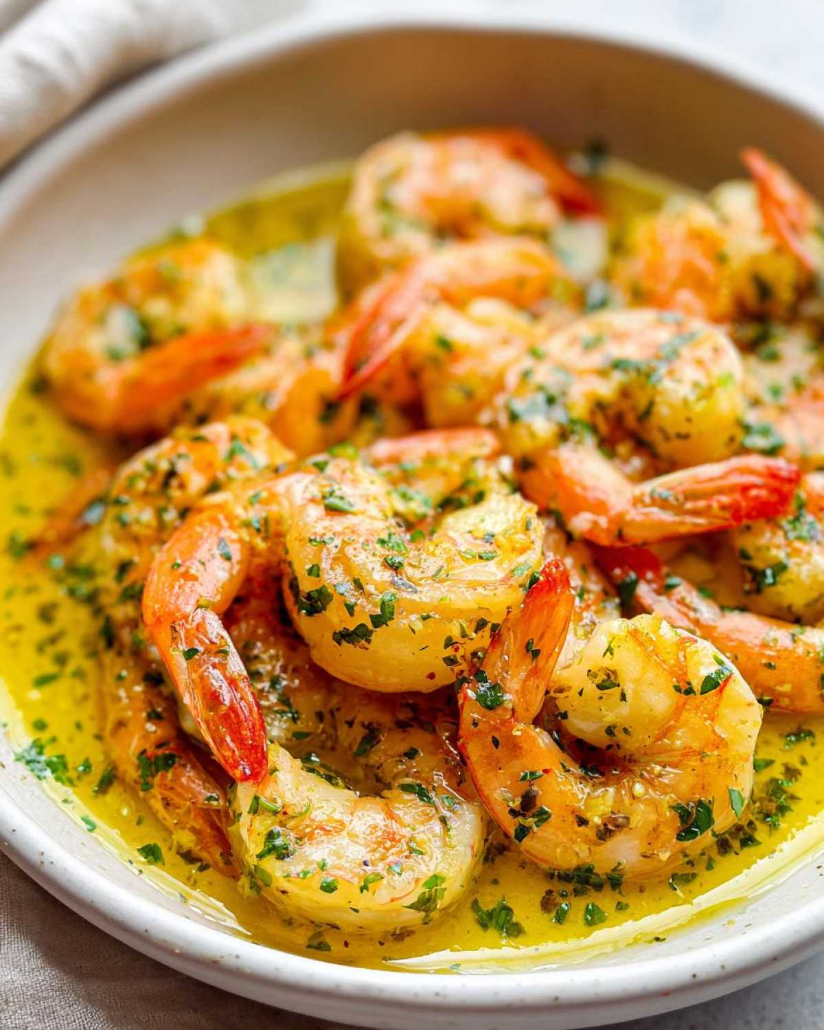 Close-up of succulent Lemon Garlic Shrimp coated in a rich, buttery sauce and topped with fresh parsley.