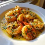 Close-up of plump, cooked Lemon Garlic Shrimp coated in a buttery sauce and fresh parsley.