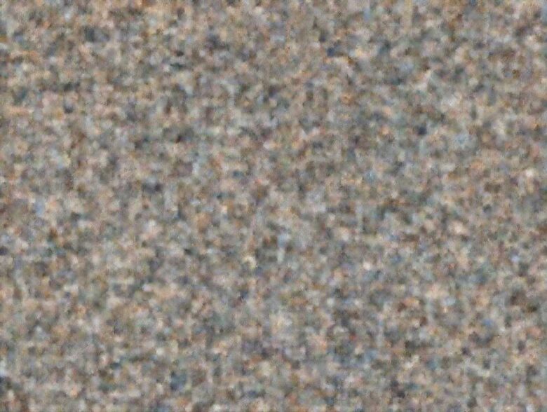 Abstract, grainy background texture, possibly representing a countertop or surface near the Strawberry Shortcake.